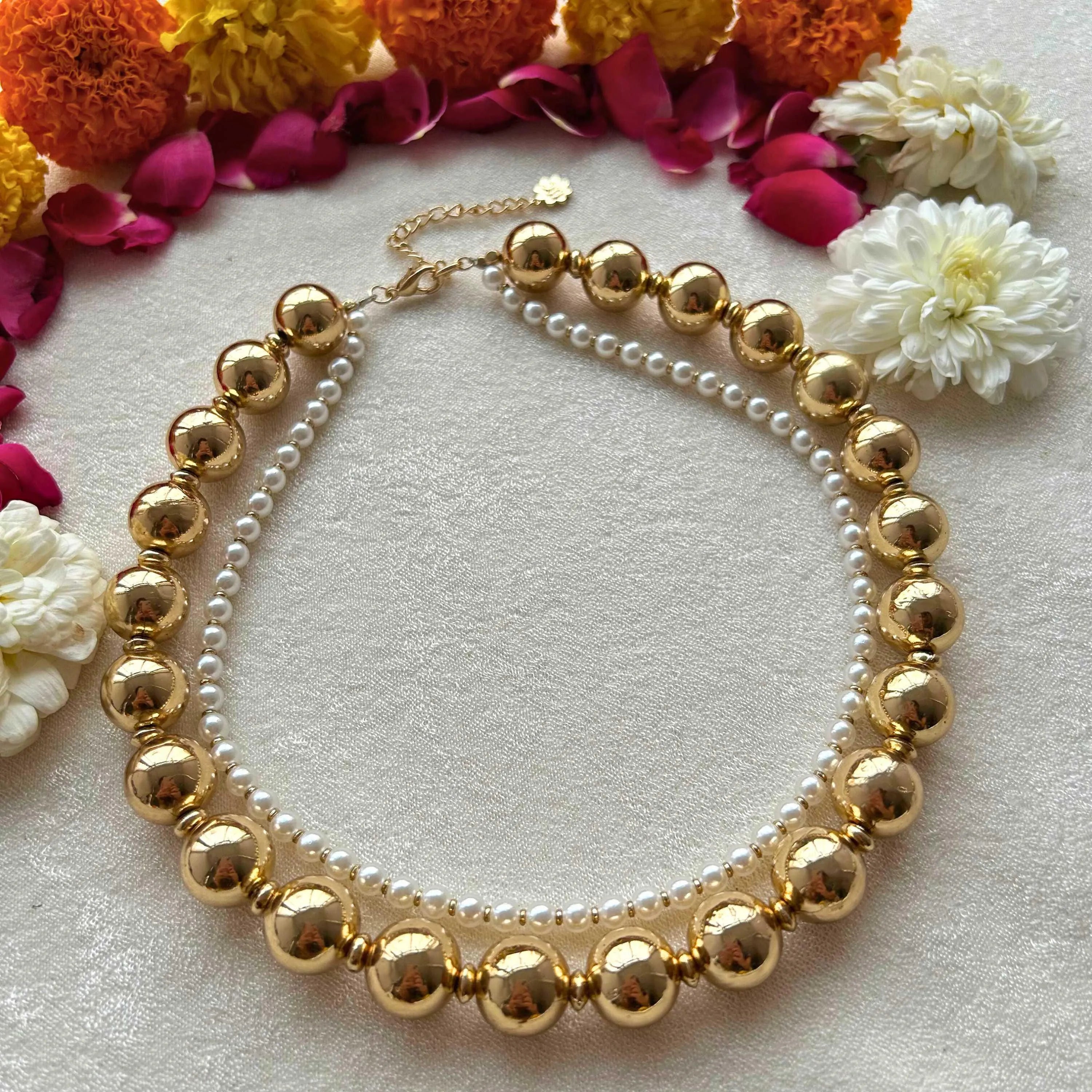TFC Gold Beads and Pearl Layer Necklace-Enhance your elegance with our collection of gold-plated necklaces for women. Choose from stunning pendant necklaces, chic choker necklaces, and trendy layered necklaces. Our sleek and dainty designs are both affordable and anti-tarnish, ensuring lasting beauty. Enjoy the cheapest fashion jewellery, lightweight and stylish- only at The Fun Company.