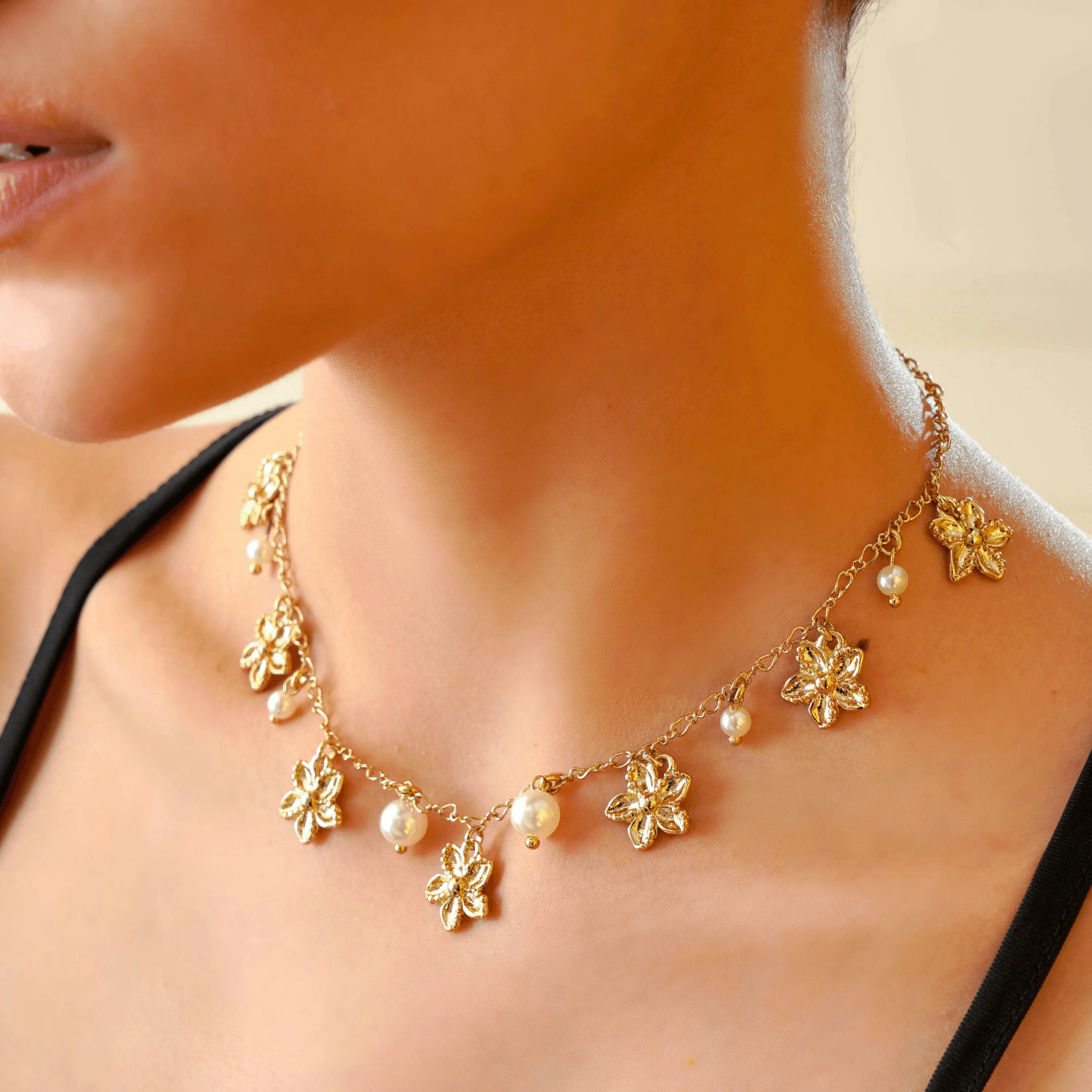 TFC Playful Pearls and Flowers Gold Plated Necklace-Enhance your elegance with our collection of gold-plated necklaces for women. Choose from stunning pendant necklaces, chic choker necklaces, and trendy layered necklaces. Our sleek and dainty designs are both affordable and anti-tarnish, ensuring lasting beauty. Enjoy the cheapest fashion jewellery, lightweight and stylish- only at The Fun Company