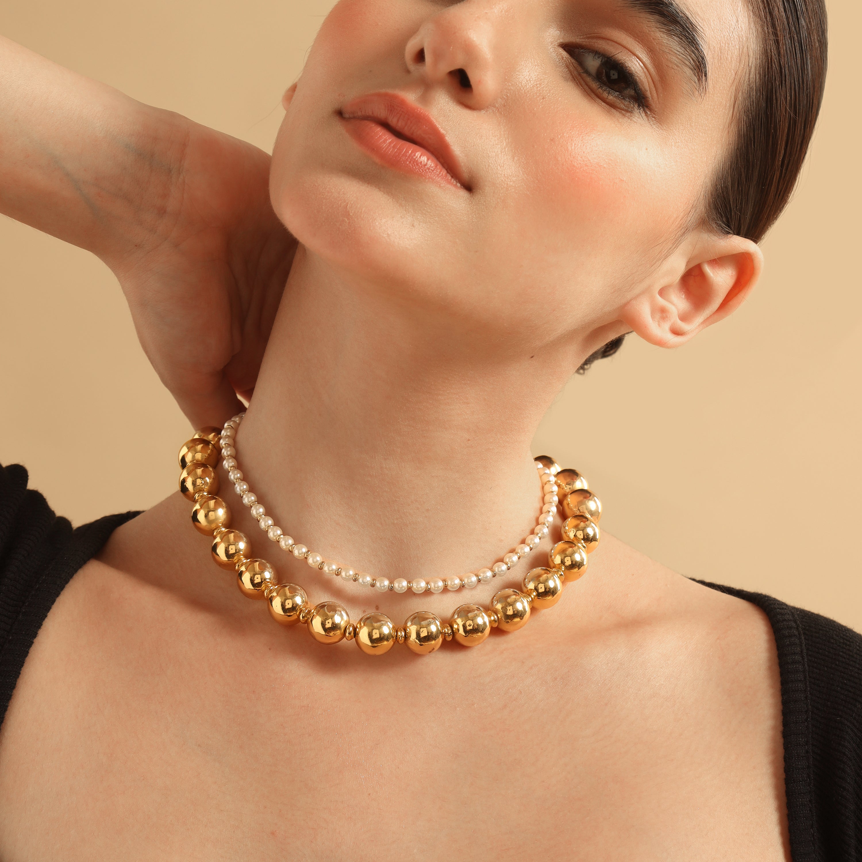 TFC Gold Beads and Pearl Layer Necklace-Enhance your elegance with our collection of gold-plated necklaces for women. Choose from stunning pendant necklaces, chic choker necklaces, and trendy layered necklaces. Our sleek and dainty designs are both affordable and anti-tarnish, ensuring lasting beauty. Enjoy the cheapest fashion jewellery, lightweight and stylish- only at The Fun Company.
